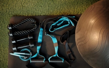 Fitness ball, triceps rope and various resistance bands ready for training in gym